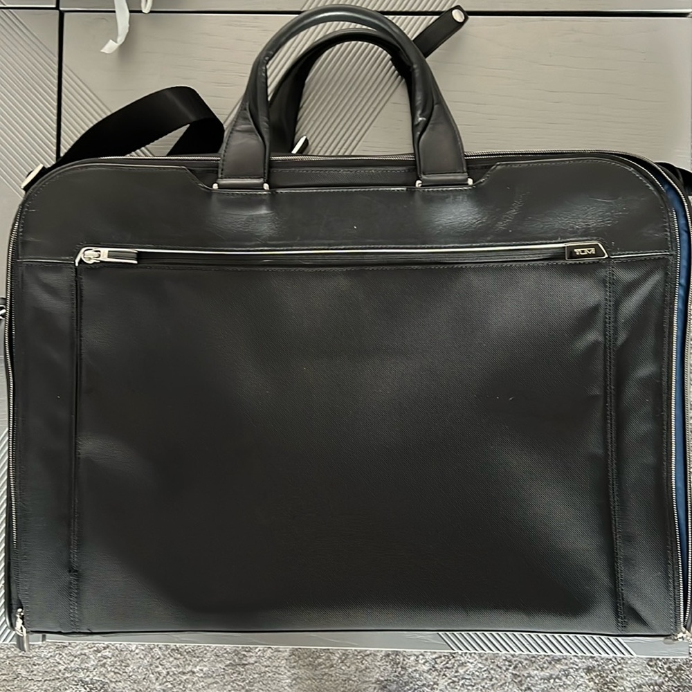 TUMI garment bag and suitcase with shoulder strap.  Leather handles. Used once.